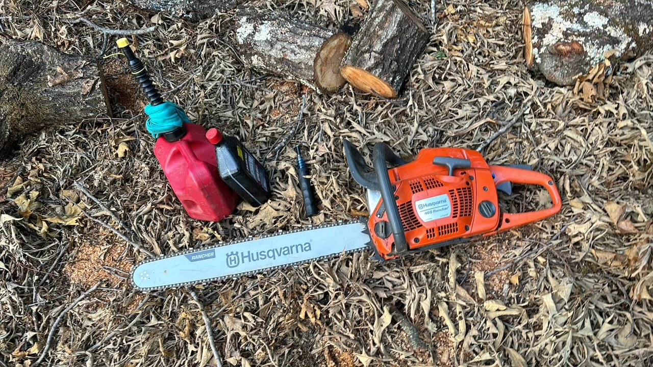 Chainsaw and supplies used to cut up a storm downed tree